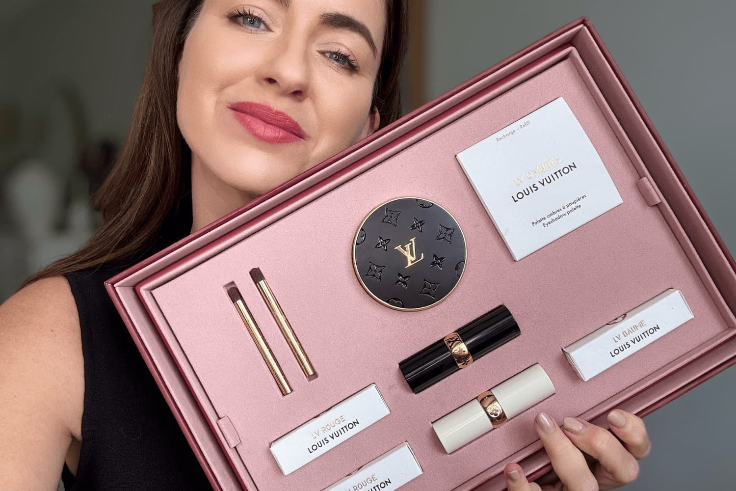 Louis Vuitton luxury lipstick in deep blood-red packaging with velvet-lined case and refillable components