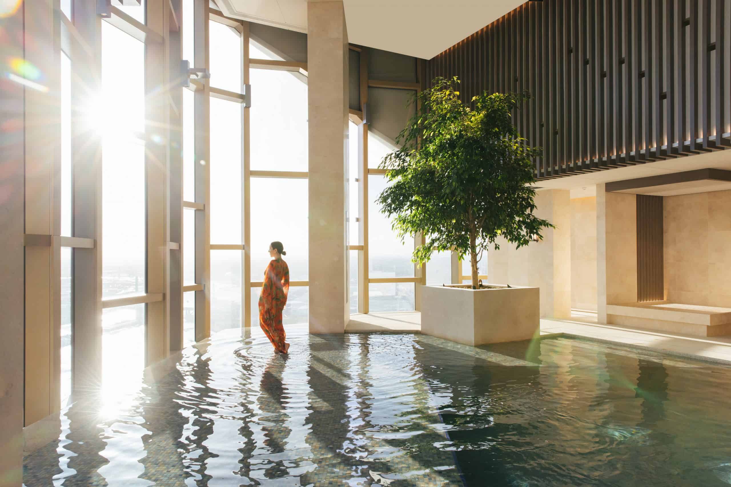 Panoramic view of Melbourne skyline from a luxurious spa treatment room with floor-to-ceiling windows