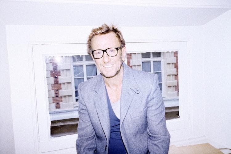 David Mallet in his Paris salon surrounded by eclectic art, sculptures and a stuffed ostrich named Babeth