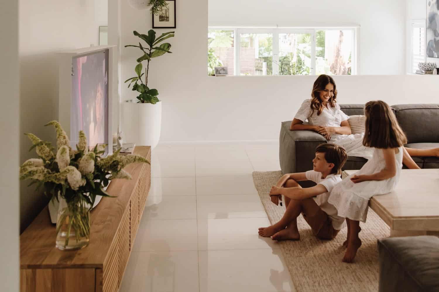 White Samsung The Serif 65-inch TV displaying artwork on cream and beige living room entertainment unit