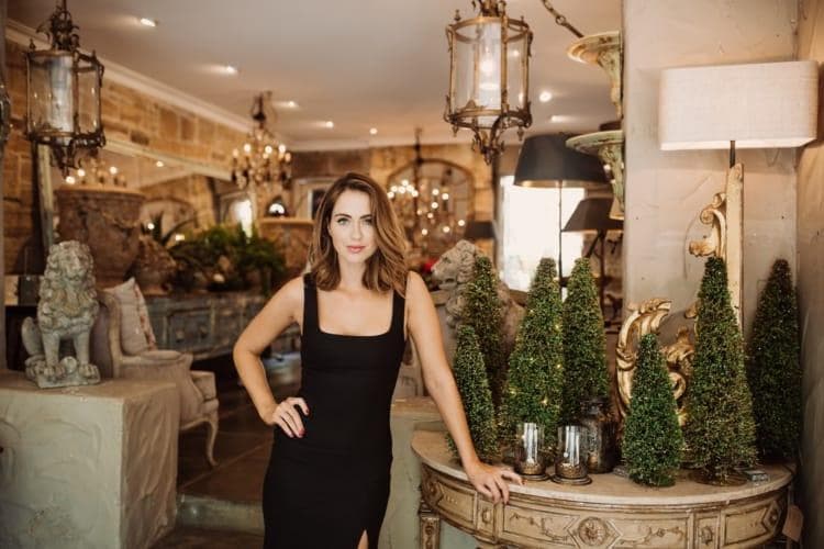 Luxury wellness products and spa items arranged on marble surface with holiday styling