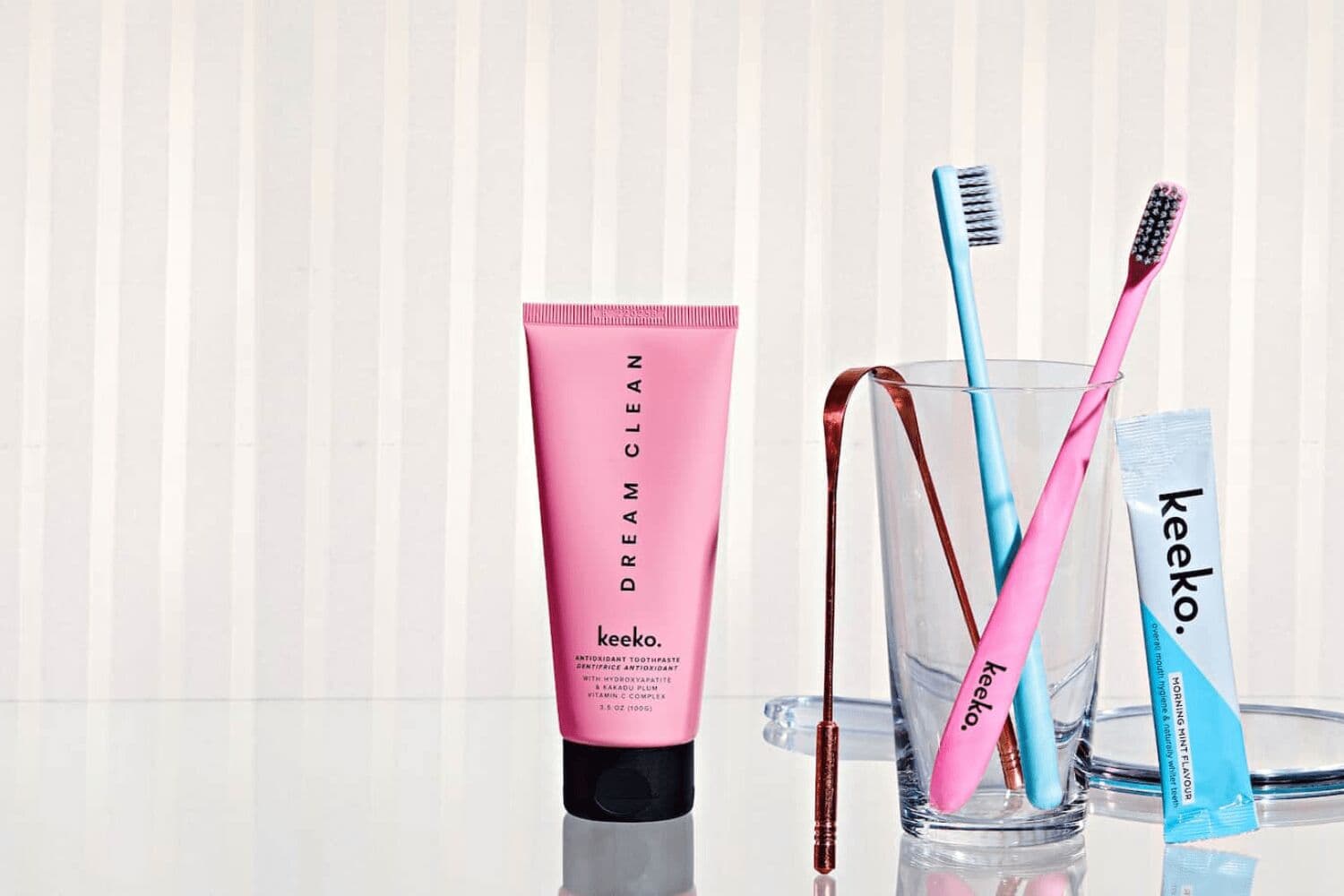 Sabrina J Parr, founder of Keeko, holding premium toothpaste and oral care products