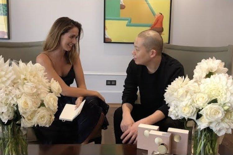 Jason Wu designer sitting for an interview, wearing a floral-print silk top