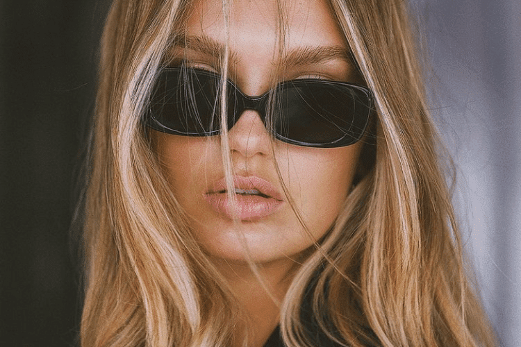 Woman with glossy, healthy-looking blonde hair after using repairing hair treatments