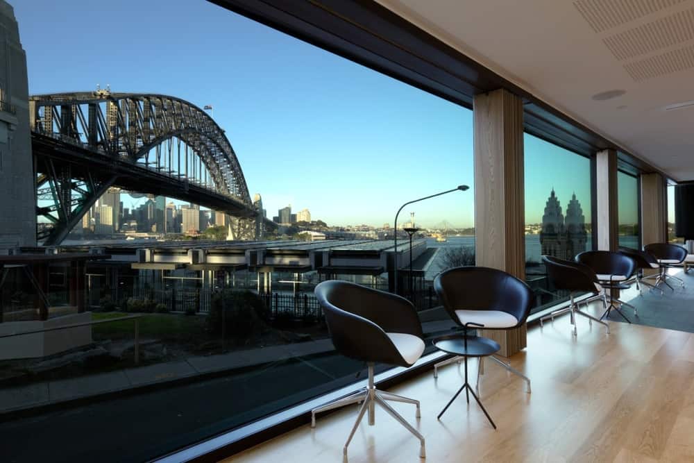 Salon interior at Wildlife Origin with floor-to-ceiling windows overlooking Sydney Harbour Bridge and waterfront views