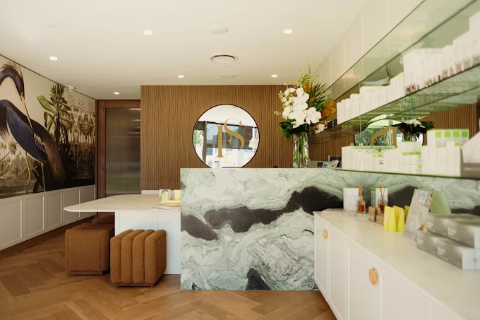 Luxurious spa treatment room with chandeliers, warm lighting and comfortable massage bed at Five Star Day Spa