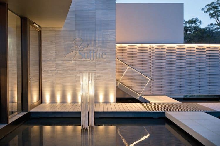 Modern spa sanctuary with curved stone and timber architecture overlooking Wineglass Bay and Freycinet Peninsula coastline