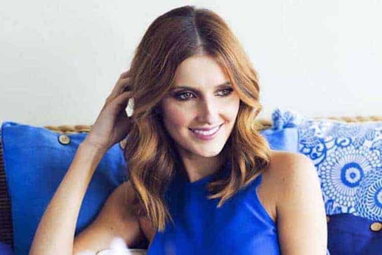 Kate Waterhouse in fresh makeup with dewy skin and bronze smoky eye, wearing race day attire