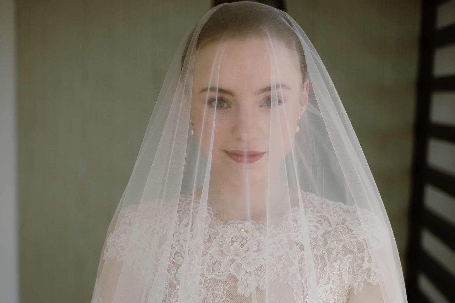 Bride with glowing skin and natural nail polish on wedding day