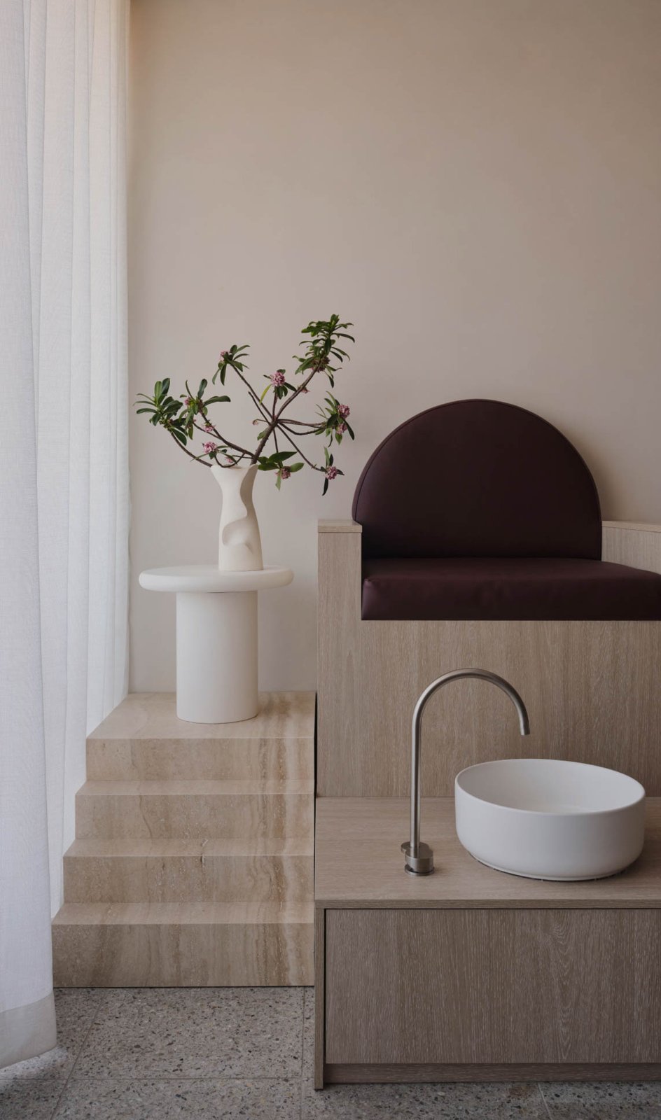 Pedicure station with a stone basin and burgundy chair at The Parlour Room, Clovelly