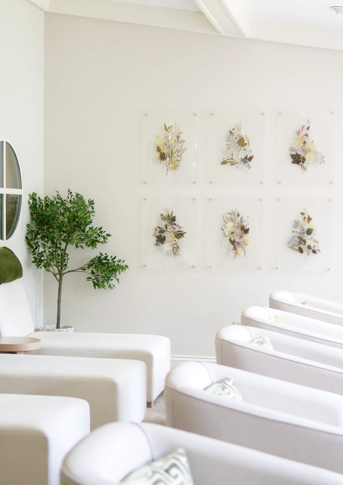 White recliners beneath framed pressed botanicals in the relaxation lounge at Chateau Elan Spa, Hunter Valley