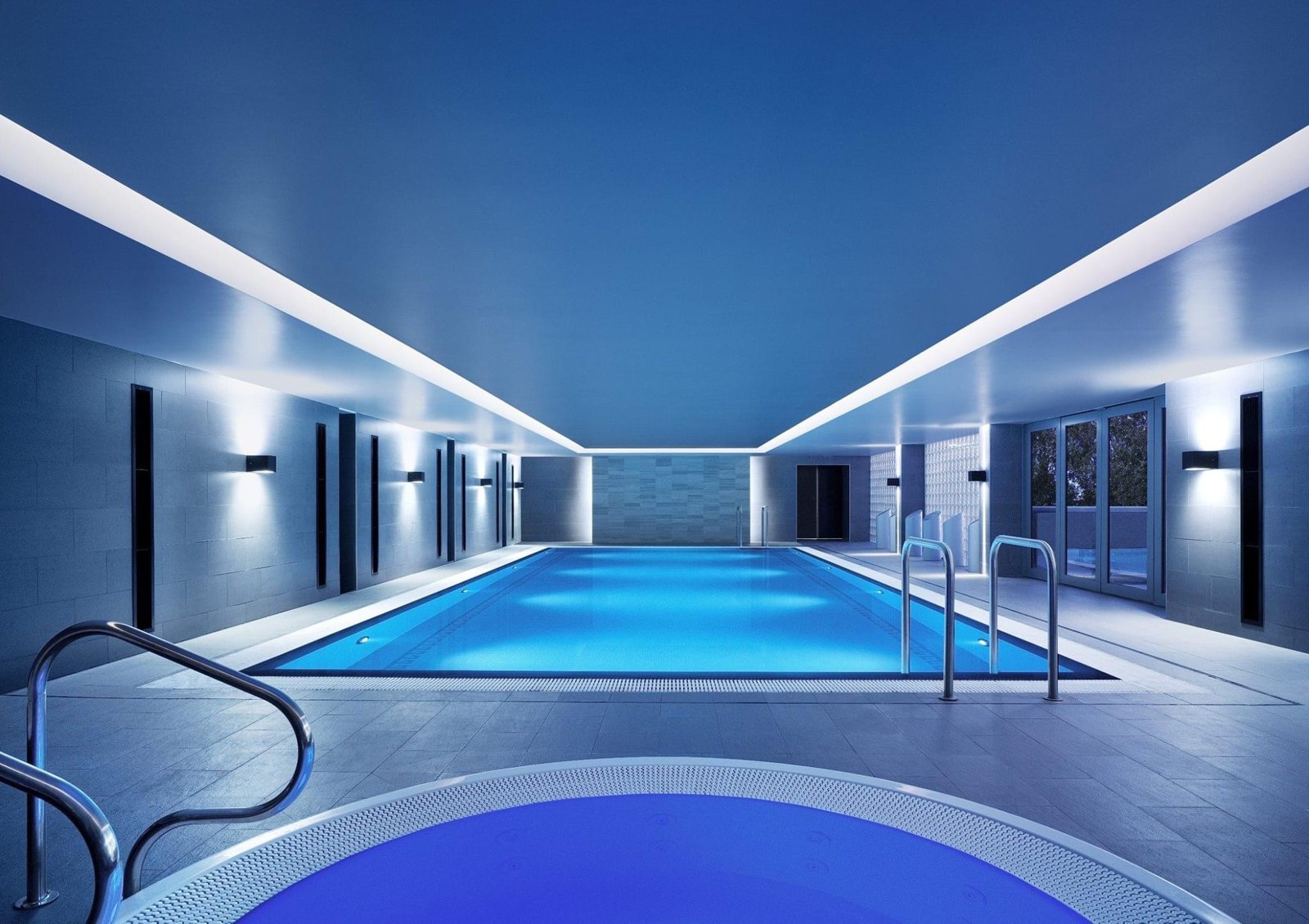 Indoor lap pool and round spa tub under soft blue lighting at CHI, The Spa, Shangri-La Hotel, Sydney
