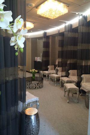 The luxurious lounge at Dr Anh medispa with chandeliers, sheer curtains and orchids