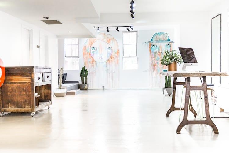 The open studio space at Edwards and Co Melbourne with vibrant wall murals, polished concrete floors and natural light