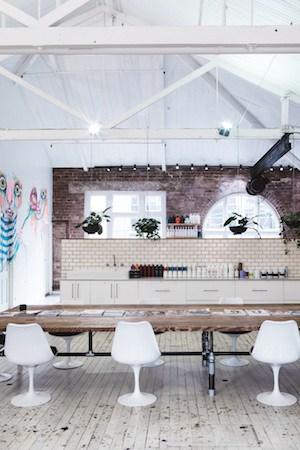 Interior of Edwards and Co salon showing the open-plan warehouse space with vaulted ceilings and natural light