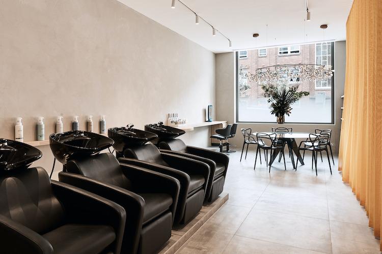 KODA Cutters reception area with blue-grey onyx desk and pendant lighting