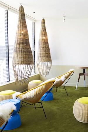 Relaxation room with sheepskin-covered Acapulco chairs overlooking the pool