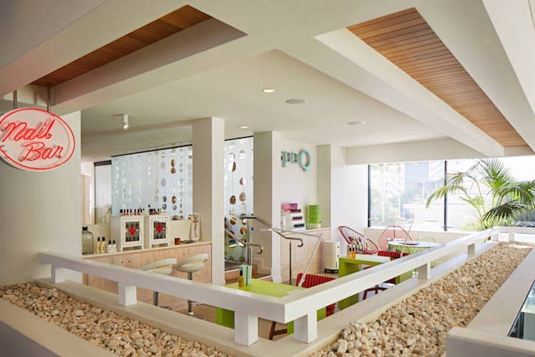 Spa Q reception at QT Gold Coast with neon signage and colourful beachy decor