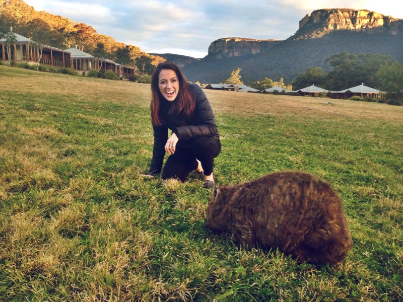 Meeting the friendly wombats at Wolgan Valley with dramatic cliff faces behind