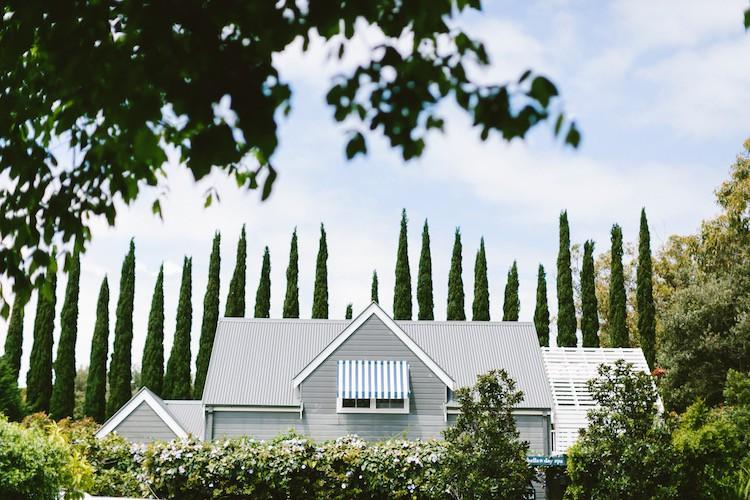 The Pretty Surrounds of Bells Features Conifers and Groomed Gardens