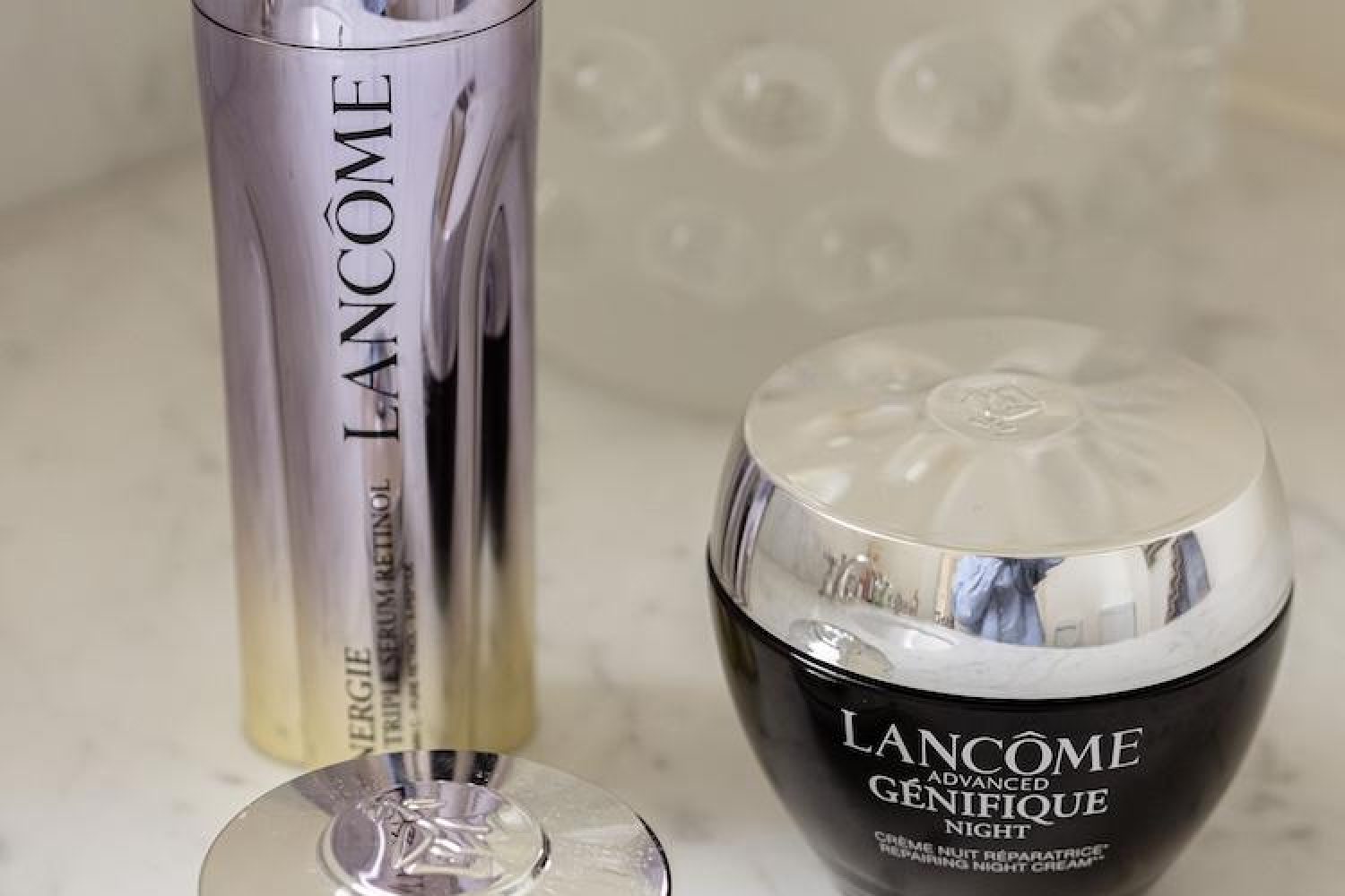 Lancome Energie Triple Serum Retinol and Advanced Genifique Night Cream on a marble countertop