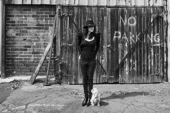 Rae Morris standing with her dog in a laneway