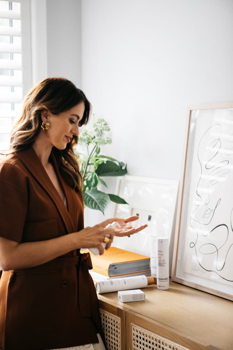 Open doors of the RJ Living Embrace sideboard showing labelled Kmart tubs for beauty storage